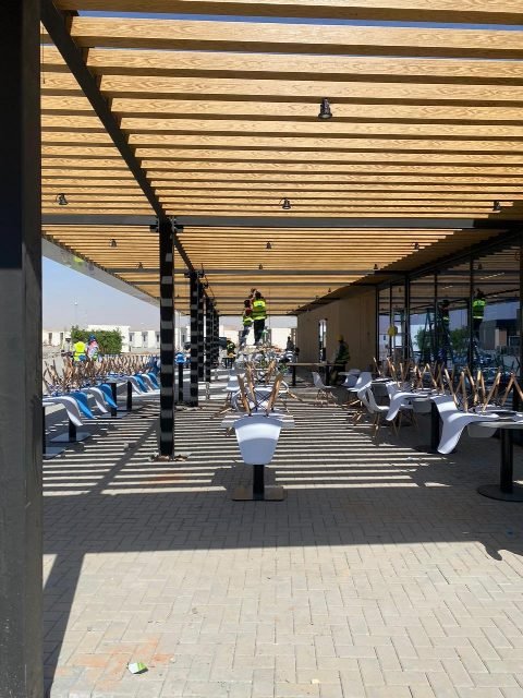 Shaded outdoor terrace under the steel canopy.