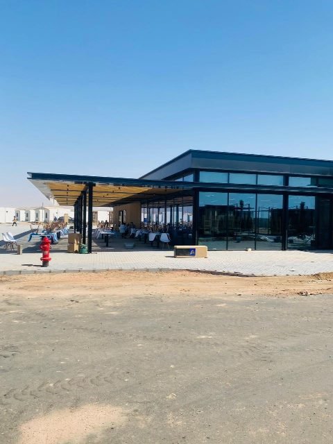 Completed building from the paved forecourt.