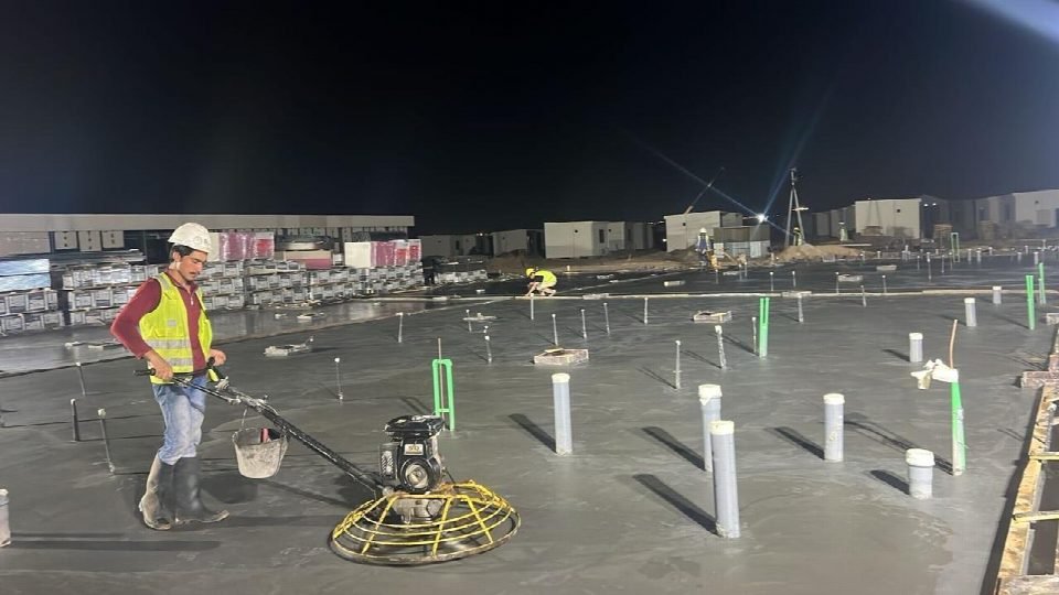 Slab finishing with a power trowel at night.
