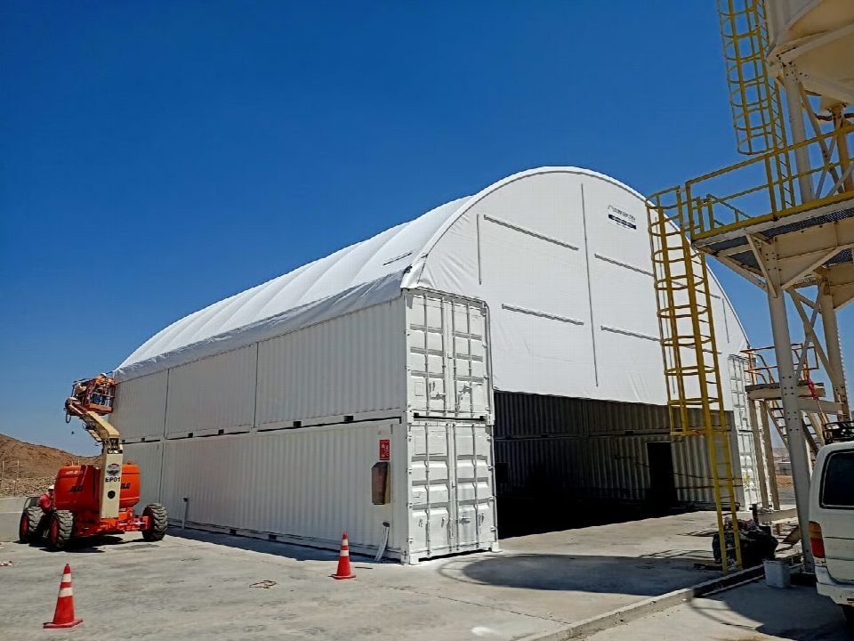 The completed dome shelter beside the plant.