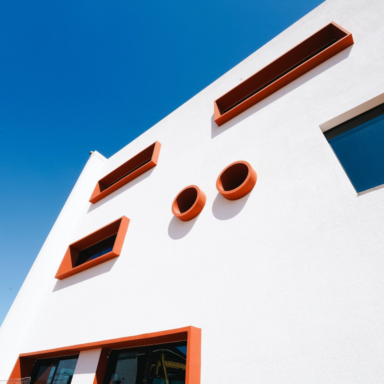 Façade detail with round and framed windows.