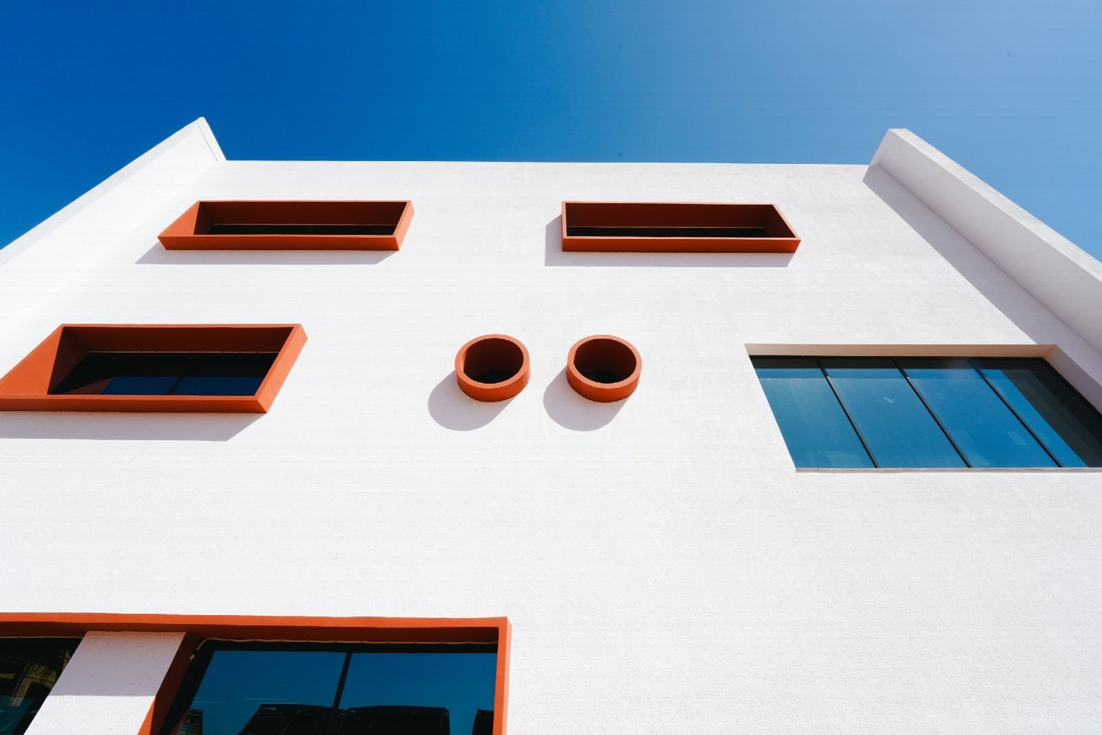 Deep-set windows on the white façade.